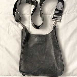 Vegan leather messenger bag with camo strap